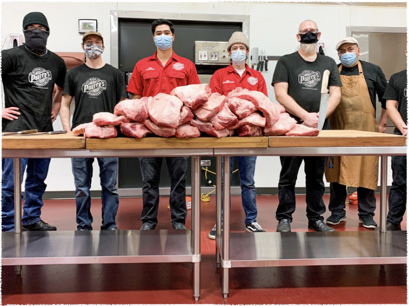 team standing in front of raw meat